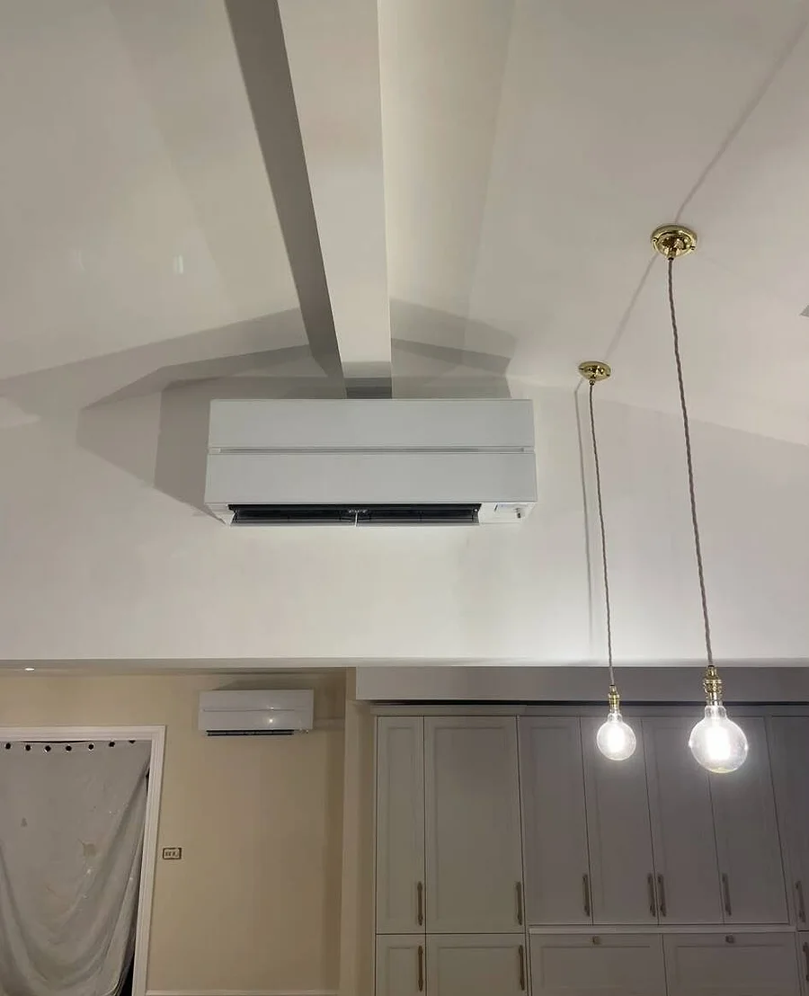 A genuine JC Heating & Cooling installation — a wall-mounted unit in a finished Manchester home